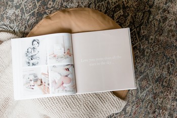 A modern baby book sits open to a quote page.
